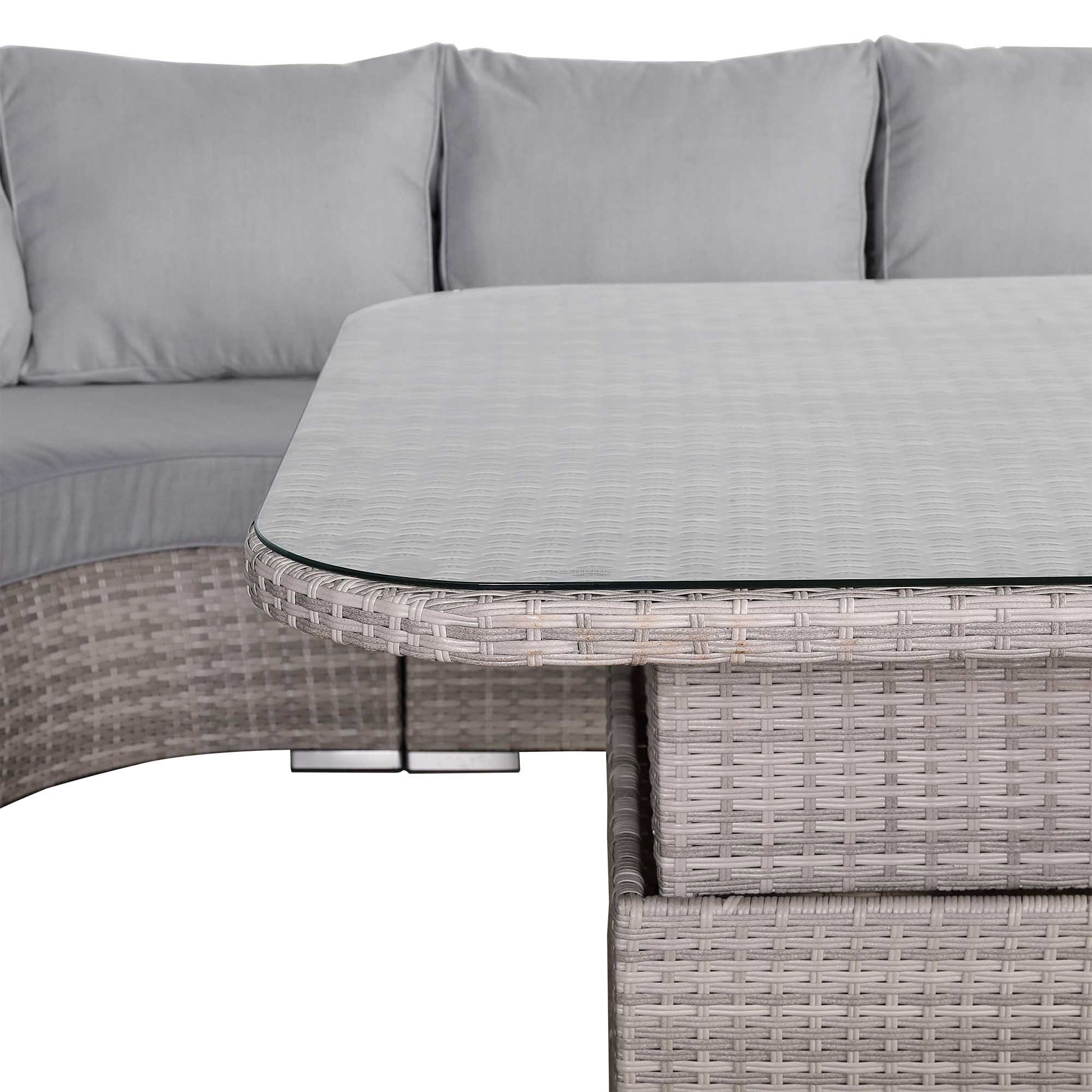 Outdoor furniture set with a sofa and glass-top table on a white background