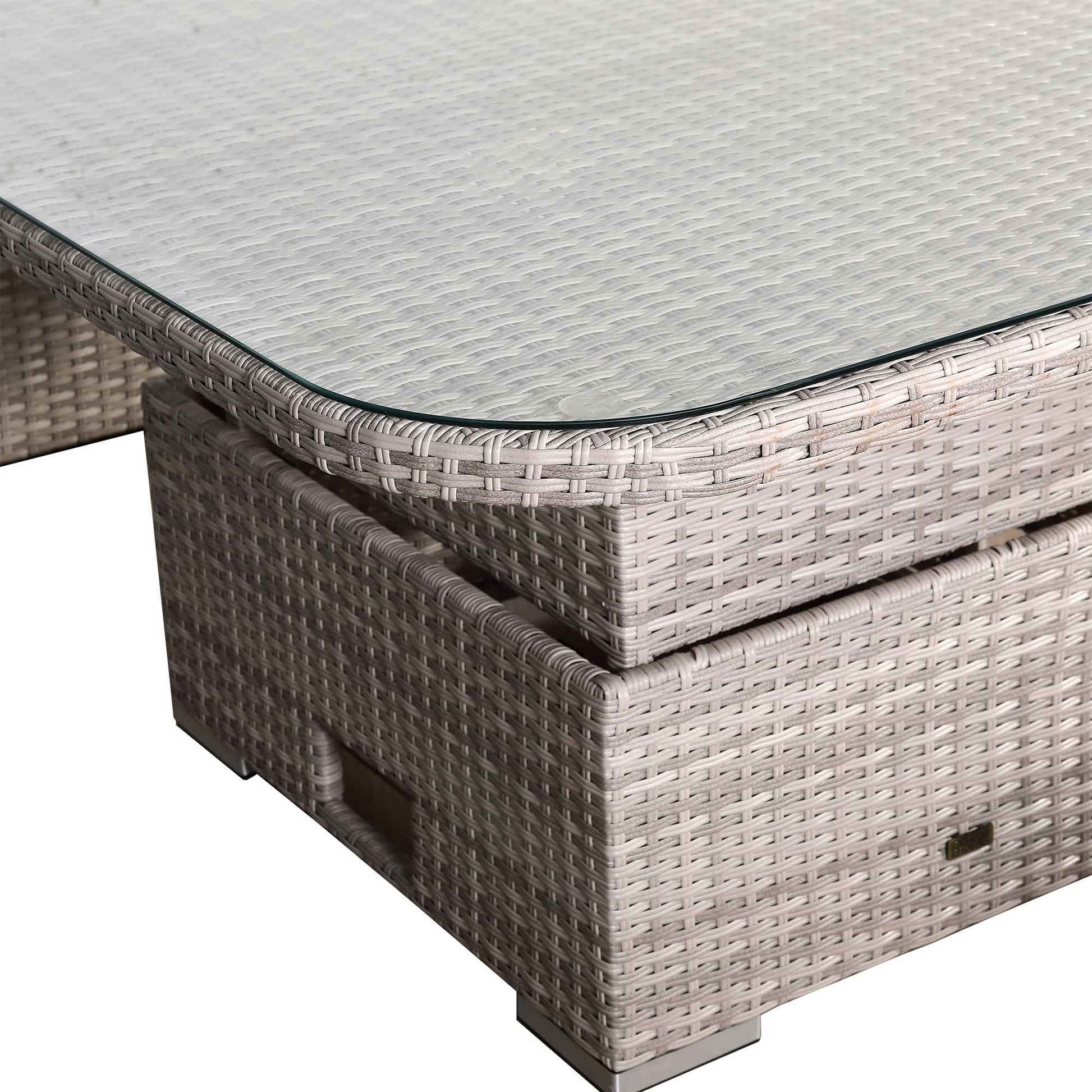 Wicker outdoor table with glass top on a white background