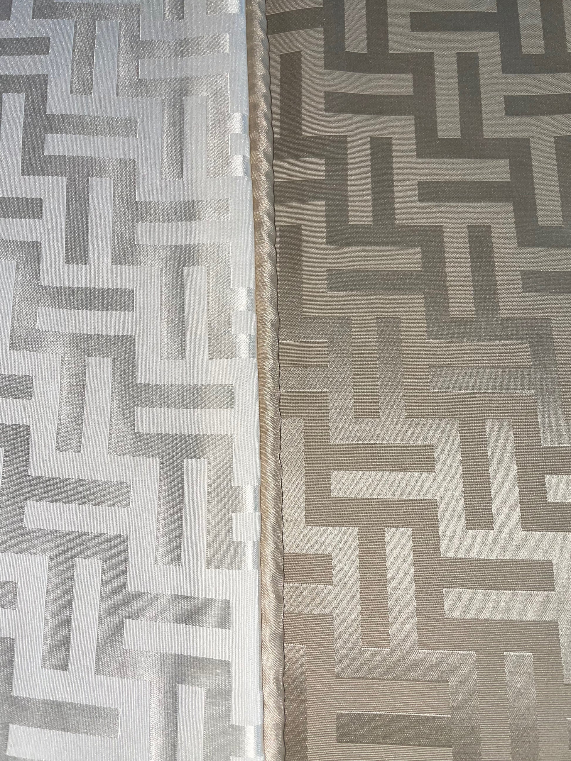 Showing the two sides of Florence Reversible Throw in Beige and White.