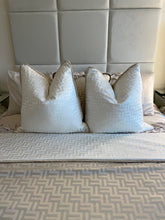 Load image into Gallery viewer, Two Florence Cushion in Beige or White, shown with the matching throw and situated on a bed with our velvet wall panels in the background.